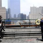 Prince Harry pauses at the World Trade Center site, as the press snaps away